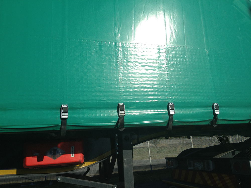 Close up view of truck side curtains with Defender security mesh for looting protection
